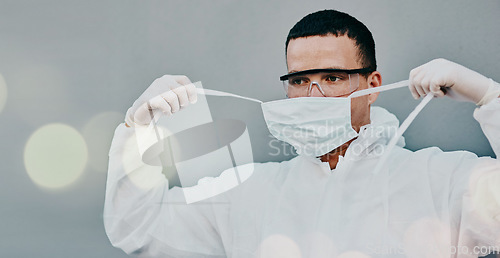 Image of PPE, face mask removal and man in safety suit of lab worker and healthcare professional in a hospital or clinic. Cleaning, bacteria protection for virus, pharmacy and wellness research with bokeh