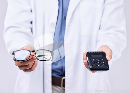 Image of Hands, glasses and machine for pos payment, healthcare and sales for optometrist by white background. Doctor, fintech and vision expert with frame, lens and helping for wellness, health or eye care