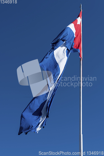 Image of Waving Cuba flag and blue sky 