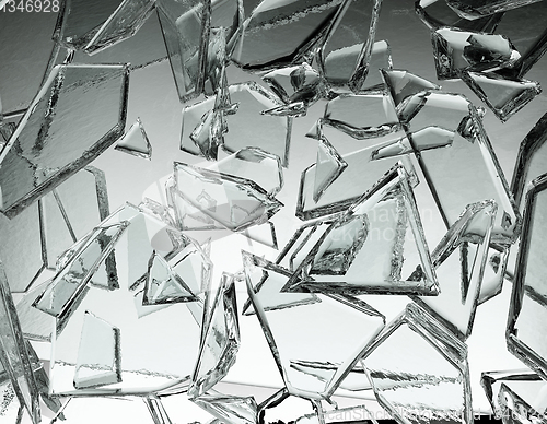 Image of Pieces of glass broken or cracked on grey