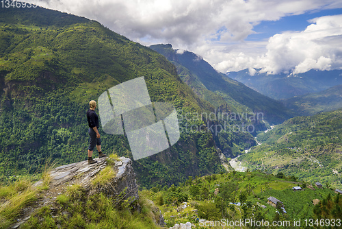 Image of Man standing on hill top in Himalayas