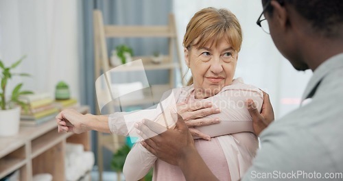 Image of Physiotherapy consultation, stretching arm and old woman for rehabilitation, recovery or advice on injury healing. Physical therapy, black man and elderly patient listening to African physiotherapist