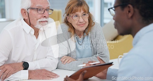 Image of Senior couple with a male financial advisor by a table in the dining room of their modern house. Conversation, meeting and elderly man and woman planning their retirement fund with accountant at home