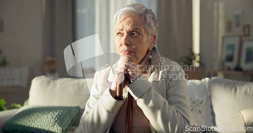 Image of Home, thinking and old woman with depression, memory and remember with thoughts, wonder and sad. Female person, mature lady and pensioner on a couch, nursing facility and retirement with Alzheimer