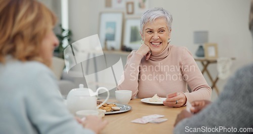 Image of Tea, happy and retirement with friends and playing cards in living room for relax, diversity and poker. Games, smile and community with group of old people in nursing home for party and celebration