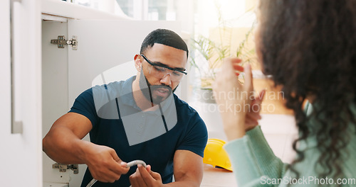 Image of Plumber black man, woman and maintenance talk in kitchen for sink pipe with customer support in home. Entrepreneur handyman, plumbing or small business owner with consulting for fixing water system