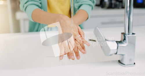 Image of Washing hands, woman cleanse and kitchen sink of a female with soap for cleaning and wellness. Home, safety and virus protection of a person with healthcare in a house for skincare and grooming