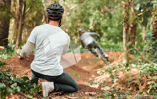 Image of Man, bicycle and forest with photographer, speed and off road for race, cycling video or post on web blog. Guy, bike and recording for vlog, live stream or social network in woods for outdoor sports