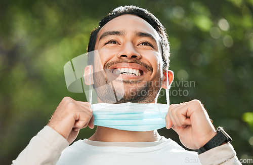 Image of Corona, Asian man and take off mask for end of pandemic, vaccine safety and outdoor protected. Covid policy, happy guy and Japanese person remove face cover for breathing and decrease infection rates