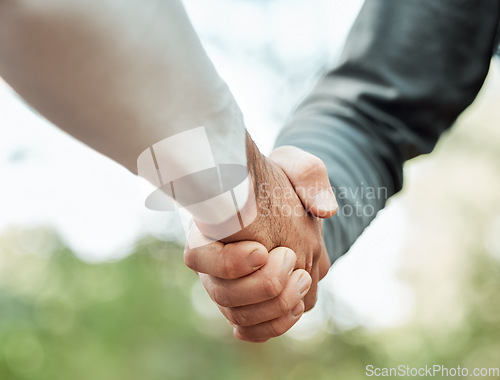 Image of Closeup, people and shaking hands outdoor for meeting, introduction or hello in support, success or team. Handshake, thank you or collaboration of friends in community for solidarity, respect or deal