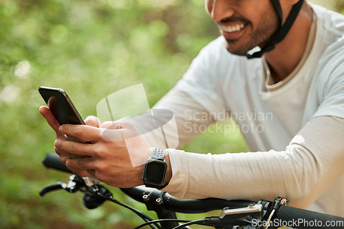 Image of Man, forest and phone on bicycle, texting or smile for web chat notification for adventure on location. Guy, cycling and smartphone for search location with bike, relax or social network app in woods