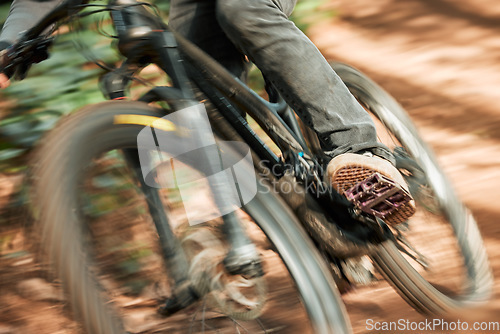 Image of Feet, mountain bike pedal and speed in forest, closeup and training for health, wellness and outdoor adventure. Person, cycling and bicycle with fast race, exercise and workout with balance off road