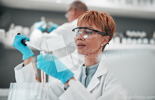 Image of Scientist, woman and dropper for test in laboratory, medical investigation and vaccine research. Expert science worker with tubes for dna analysis, healthcare innovation and development of medicine