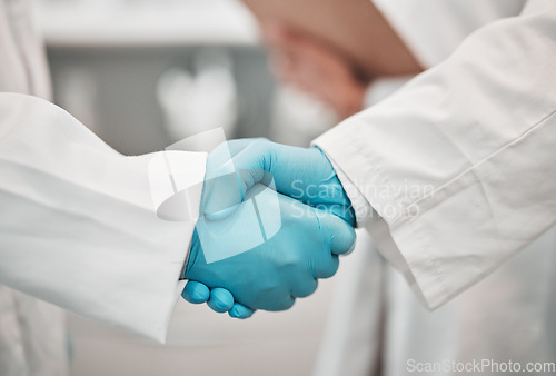 Image of Closeup, medical and research with handshake, people and agreement with promotion, cooperation and partnership. Teamwork, scientists and staff shaking hands, welcome and gloves with collaboration