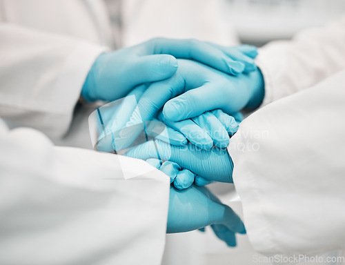 Image of Ppe, doctor and nurse hands together for teamwork, solidarity and collaboration in hospital with gloves. Medical workers, professional people and support for healthcare, motivation and community