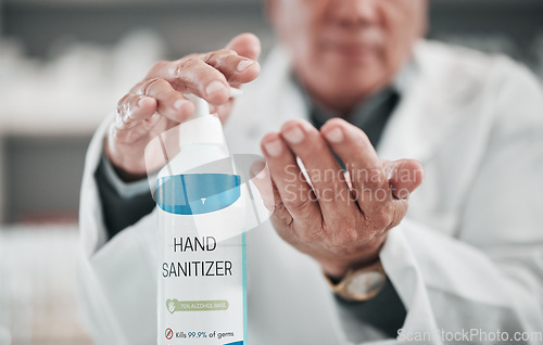 Image of Doctor, sanitizer bottle and cleaning hands for risk, hygiene and protocol in hospital, clinic and surgery. Closeup, healthcare worker and disinfection liquid for safety, flu germs and virus bacteria