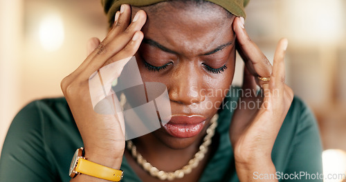 Image of Headache, stress and burnout with a business black woman suffering from tension while working in her office. Anxiety, mental health and pain with a female employee rubbing her temples in discomfort