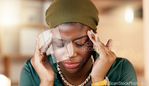 Image of Headache, stress and burnout with a business black woman suffering from tension while working in her office. Anxiety, mental health and pain with a female employee rubbing her temples in discomfort