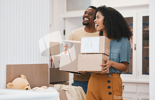 Image of Excited black couple, box and moving in new home, investment or property together in happiness. African man and woman smile with boxes in renovation, relocation or house mortgage and apartment loan