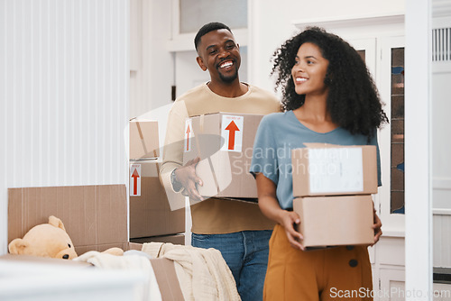 Image of Happy black couple, box and moving in new home, property or investment together in happiness. African man and woman smile with boxes in renovation, relocation or house mortgage and apartment loan