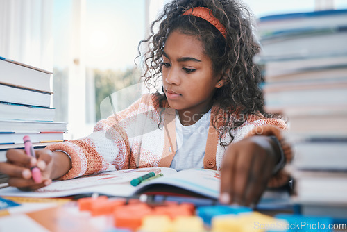 Image of Art, homework and child coloring in a book for artistic project, assignment or fun. Crayon, education and girl kid student writing for creative learning in a notebook by a desk at modern home.