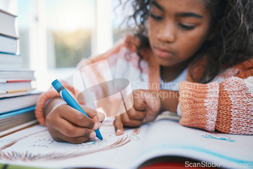 Image of Education, homework and child coloring in a book for artistic project, assignment or fun. Colors, hobby and girl kid student writing for creative learning in a notebook by a desk at modern home.