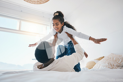 Image of Happy, airplane and father with girl child on a bed for bond, trust or support in their home together. Flying, family time and parent with kid in a bedroom for games, love or fun with weekend freedom