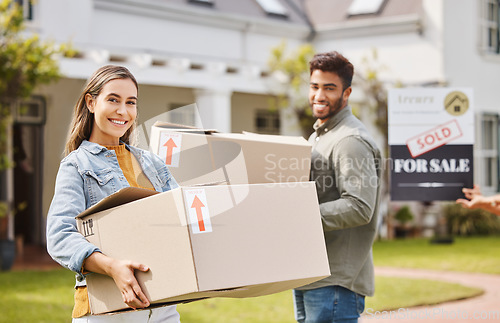 Image of Couple, boxes and portrait for new home, real estate and property, homeowner and outdoor neighborhood. Young and happy interracial people with cardboard, moving in dream house together and sold sign