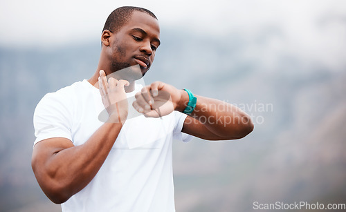 Image of Fitness, watch and pulse with a black man hiking in the forest for health, wellness or cardio on space. Exercise, time and heart rate with a young athlete in the mountains or nature for running