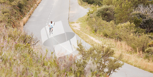 Image of Fitness, hill or runner running on a road by nature for exercise, training or outdoor workout. Sports race, fast black man or healthy active athlete on street with endurance, freedom or challenge