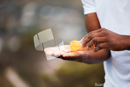 Image of Pills, space and medicine with hands of person in nature for healthcare, pharmacy and supplements. Vitamins, medical and wellness with closeup of man and medication for antibiotics and mockup