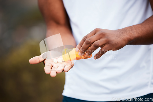 Image of Health, hands and person with supplements for fitness and energy, pills and vitamins with pharmacy and outdoor. Athlete, performance enhancement drugs and wellness, healthcare and pharmaceutical