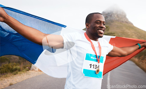 Image of Winner celebration, flag and happy black man, runner and marathon victory of challenge, sports competition or race. Cardio, road and France athlete running with pride, success goals and gold medal