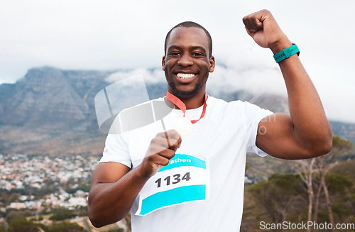 Image of Runner man, celebration and medal in portrait for marathon, competition or race with smile in Cape Town. African winner guy, champion and goal in challenge, contest or fist for metal prize in nature