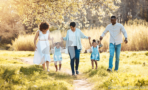 Image of Walking, holding hands and family generations in nature at an outdoor park together for bonding. Love, fun and children with grandmother and parents in a green garden on weekend trip or holiday.