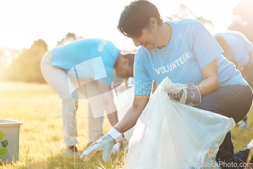 Image of Nature recycling, community service volunteer and happy woman cleaning garbage, trash or pollution. Earth Day teamwork, eco friendly environment and charity team help with sustainable park clean up