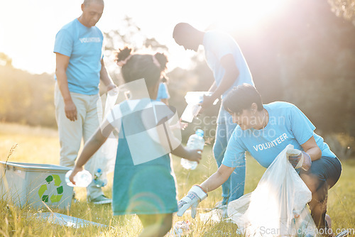 Image of Nature team, volunteering family and child cleaning garbage pollution, waste litter or plastic bottle. Group teamwork, NGO support and kid helping with park clean up, outreach project or field trash