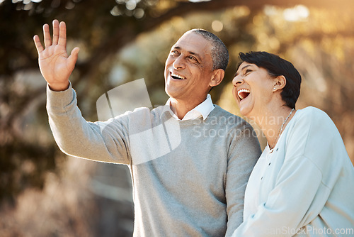 Image of Happy, laugh and senior couple in a park on an outdoor date for romance, bonding or love. Smile, talking and elderly man and woman in retirement in conversation walking in a field together at sunset.