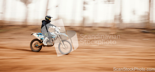 Image of Motorcycle, speed and motion blur with a sports man on space in the forest for dirt biking. Bike, fitness and power with a person driving fast on an off road course for freedom or performance