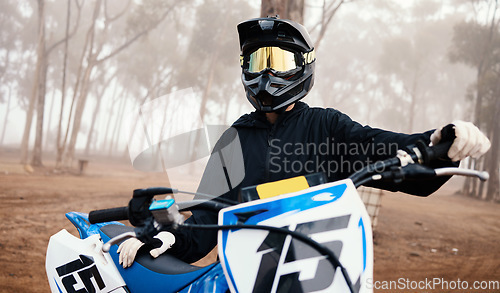 Image of Motorcycle, person and sport in forest with training for competition, ride in nature with action and helmet. Extreme, adrenaline and exercise, athlete and transport with dirt bike, freedom and travel