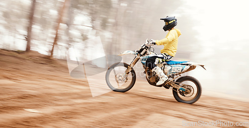 Image of Motorcycle, speed and uphill with a sports man on space in the forest for dirt biking. Bike, fitness and power with a person driving fast on an incline or off road course for freedom or performance