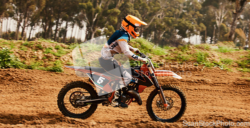 Image of Motorcycle, training and speed with a sports man on space in the forest for dirt biking. Bike, fitness and power with a person driving fast on an off road course for freedom, challenge or performance