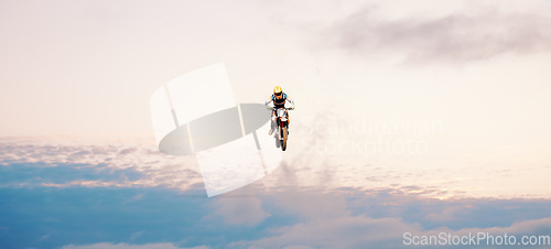 Image of Motorcycle, blue sky and jump for training or sports with fitness, balance or challenge in nature on mock up space. Bike, freedom and adventure for competition, exercise or talent with safety gear