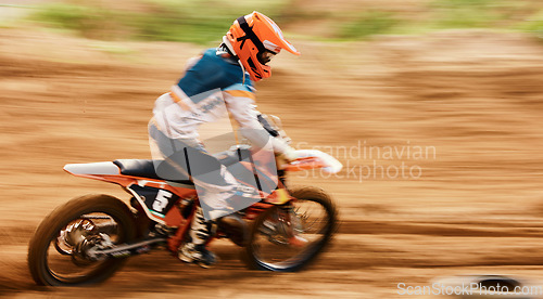 Image of Motorcycle, sand and motion blur with a sports man on space in the desert for dirt biking. Bike, fitness and speed with a person driving on an off road course for freedom or performance closeup