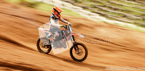 Image of Bike, training and motion blur with a sports man on space in the desert for dirt biking. Motorcycle, fitness and power with a person driving at speed off road on sand for freedom or performance