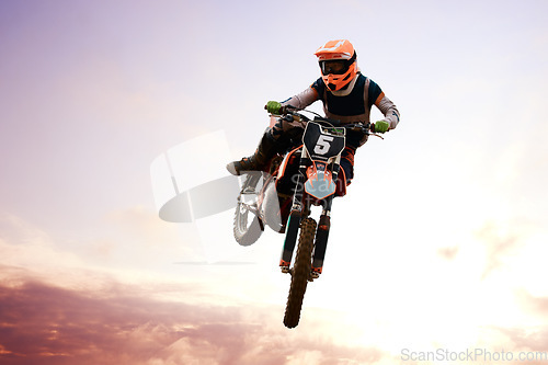 Image of Motorcycle, person and jump for training or sports with fitness, balance or challenge in nature on mock up space. Bike, freedom and adventure for competition, exercise or talent with safety gear