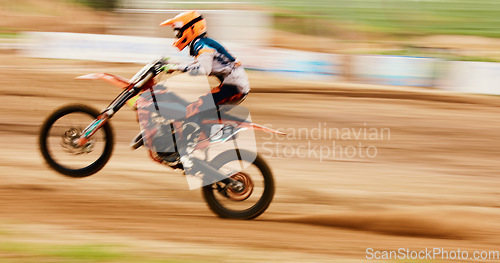 Image of Motorcycle, balance and motion blur with a man training for a race or dirt biking challenge on space. Bike, fitness and power with a person driving fast on an off road course for freedom or speed