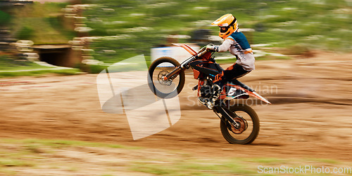 Image of Motorcycle, balance and motion blur with a man at a race on space in the forest for dirt biking. Bike, fitness and power with a sports person driving fast on an off road course for freedom or speed
