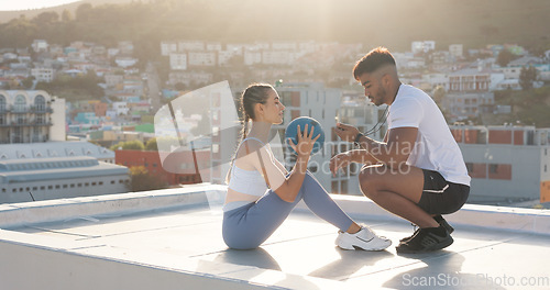 Image of Exercise, time and a personal trainer with a woman on rooftop outdoor for fitness, workout or training. Couple of friends in city with medicine ball, motivation and support for sit up challenge