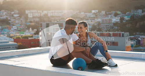 Image of Fitness, rest and happy couple outdoor for exercise, workout or training together on a city building rooftop. Man and woman on urban break with medicine ball, conversation or health and wellness